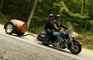 wood barrel motorcycle trailer behind Harley
